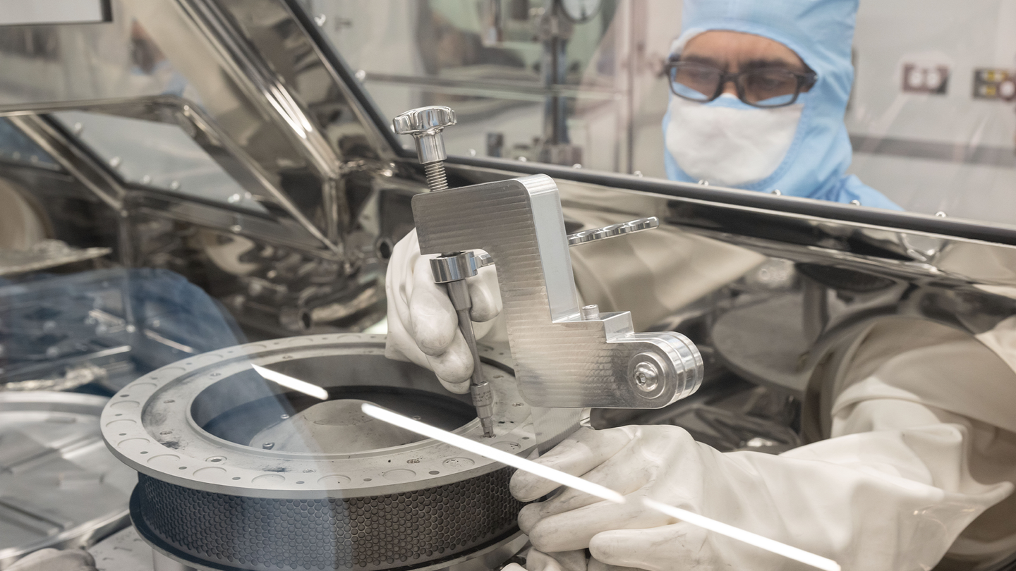 NASA’s OSIRIS-REx curation engineer, Neftali Hernandez, attaches one of the tools developed to help remove two final fasteners that prohibited complete disassembly of the Touch-and-Go Sample Acquisition Mechanism head that holds the remainder of material collected from asteroid Bennu. Engineers on the team, based at NASA’s Johnson Space Center in Houston, developed new tools that freed the fasteners on January 10.